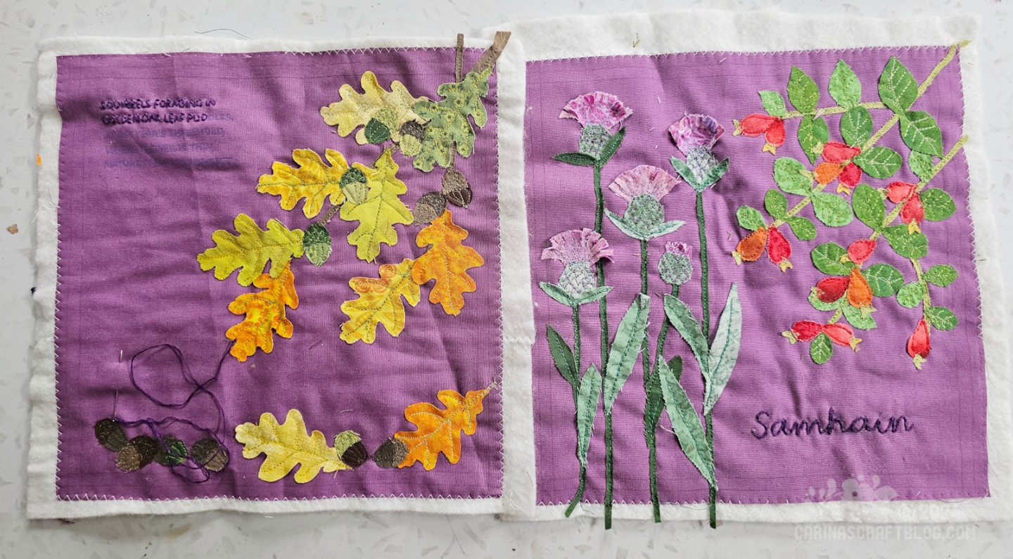 Overhead view of two purple squares of fabric with appliqué. On the left hand square is a small branch of oak leave in autumn colours, at the bottom of the square are more leaves and several acorns. On the right hand square are thistles and a rosehip branch.