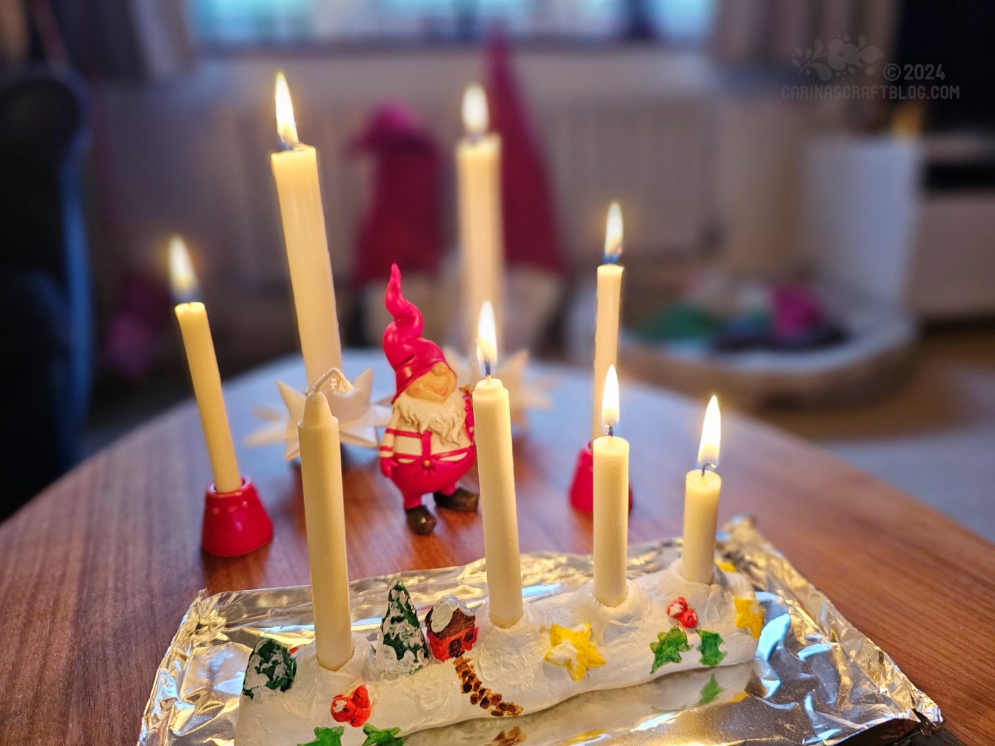 Photo of white candles of varying sizes and varying states of burning.